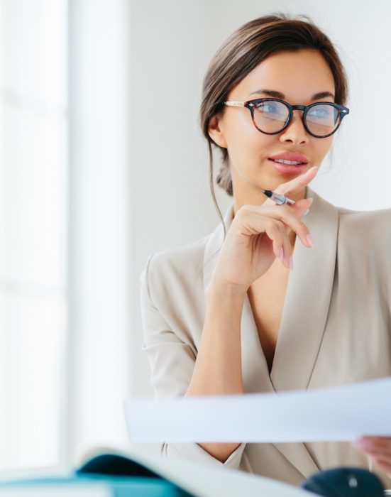 economist poses in coworking space, focused in monitor, verifies or checks figures