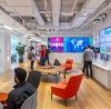 a sleek, modern office environment showcases a group of diverse professionals actively collaborating over digital marketing strategies, with vibrant graphics of social media and analytics displayed on large screens to emphasize the importance of instagram ads and google advertising services.